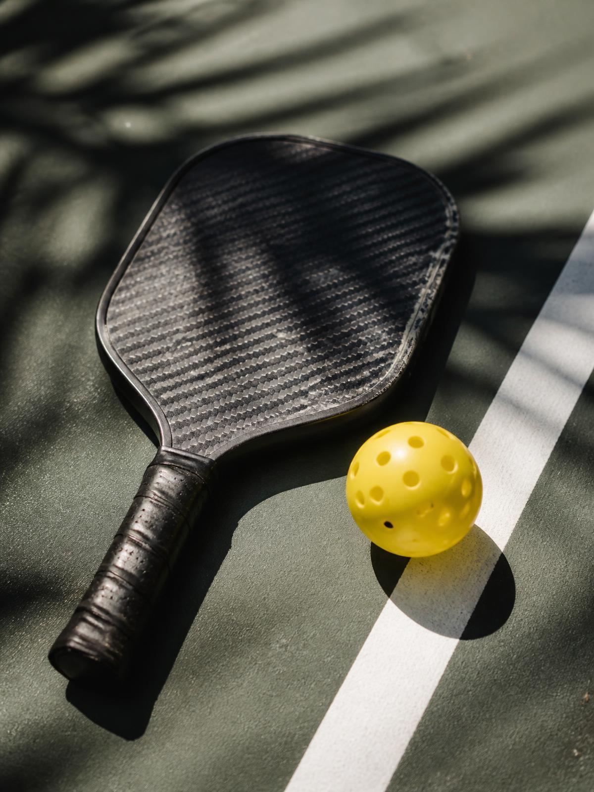 Paddle and ball on court