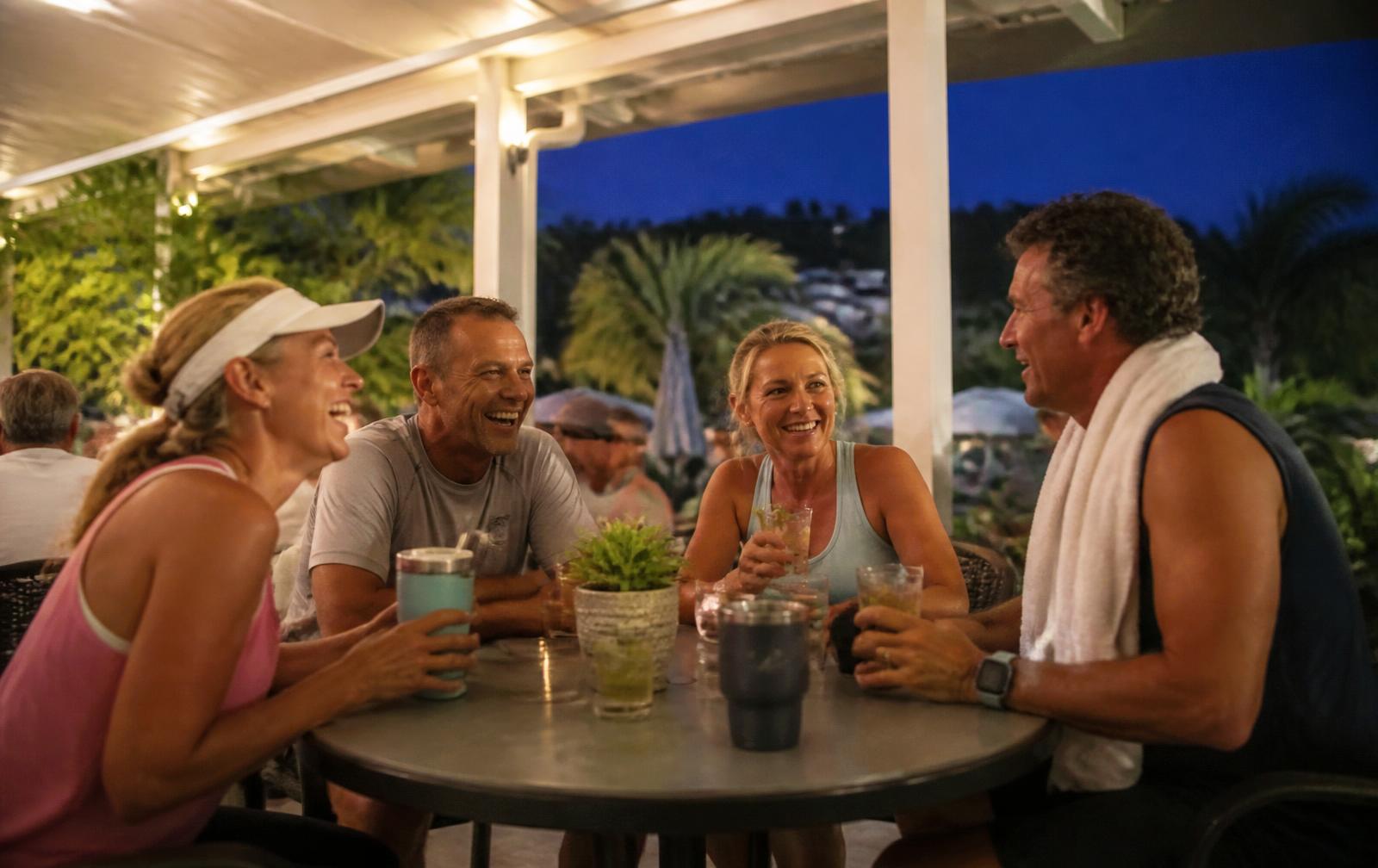 Players sitting around a clubhouse table in the evening